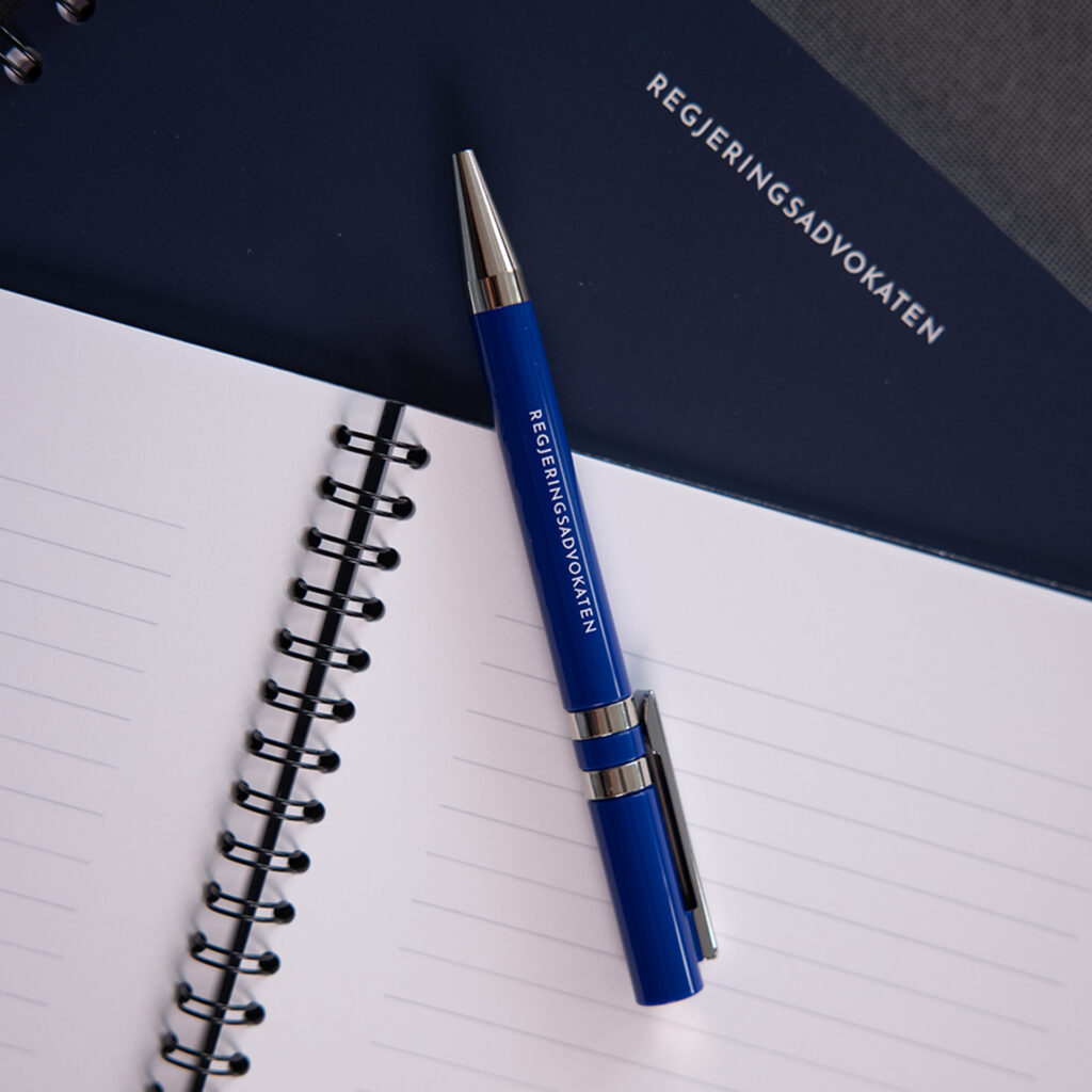 Image of a pad of paper and pen with the logo of the Government Attorney.